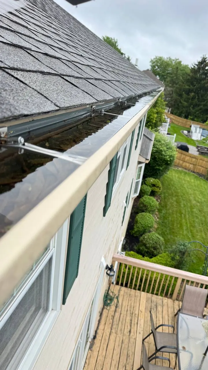 Clogged gutter full of leaves and debris before cleaning, Bucks County home